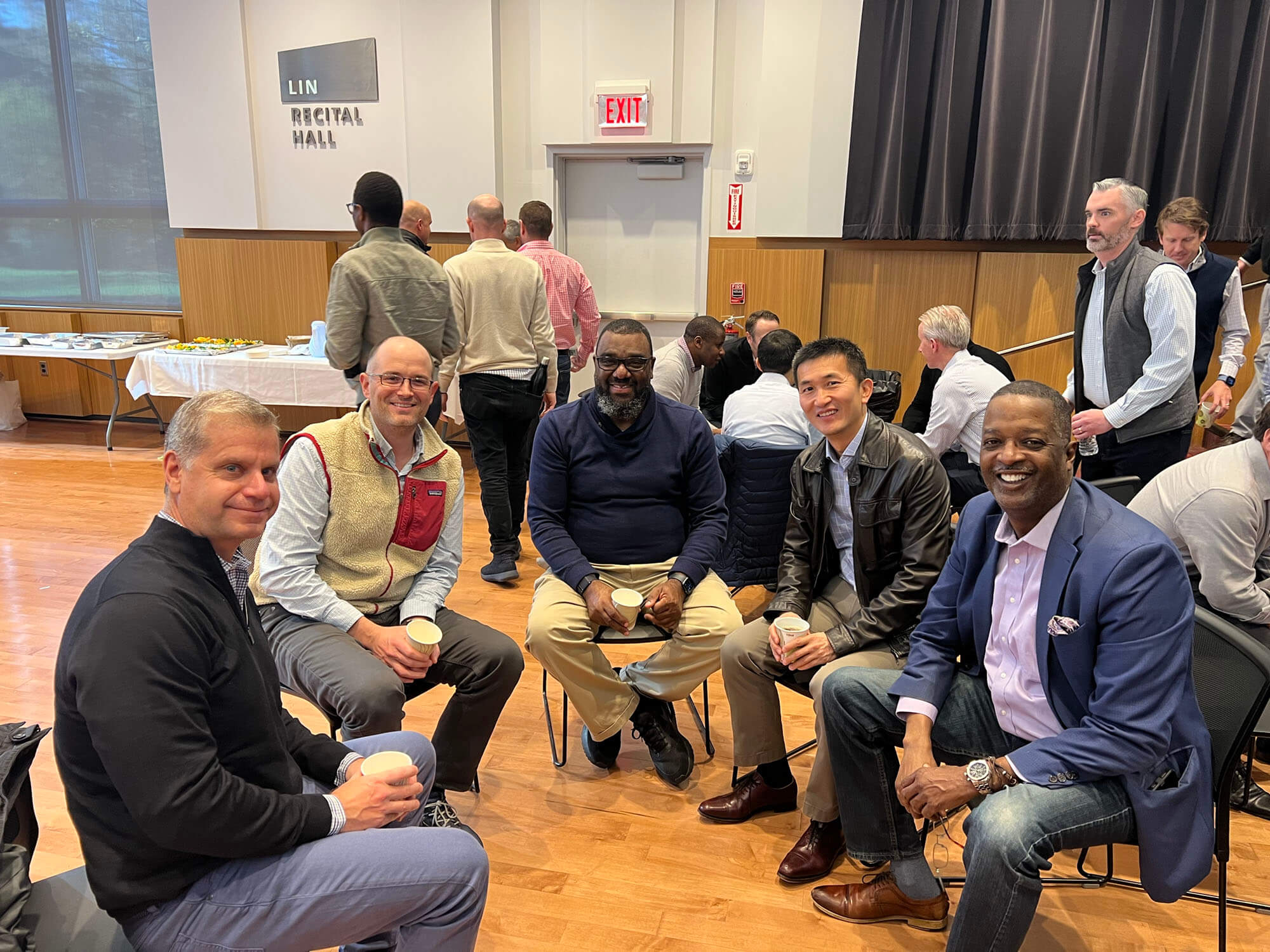 Men sitting in chairs in a circle