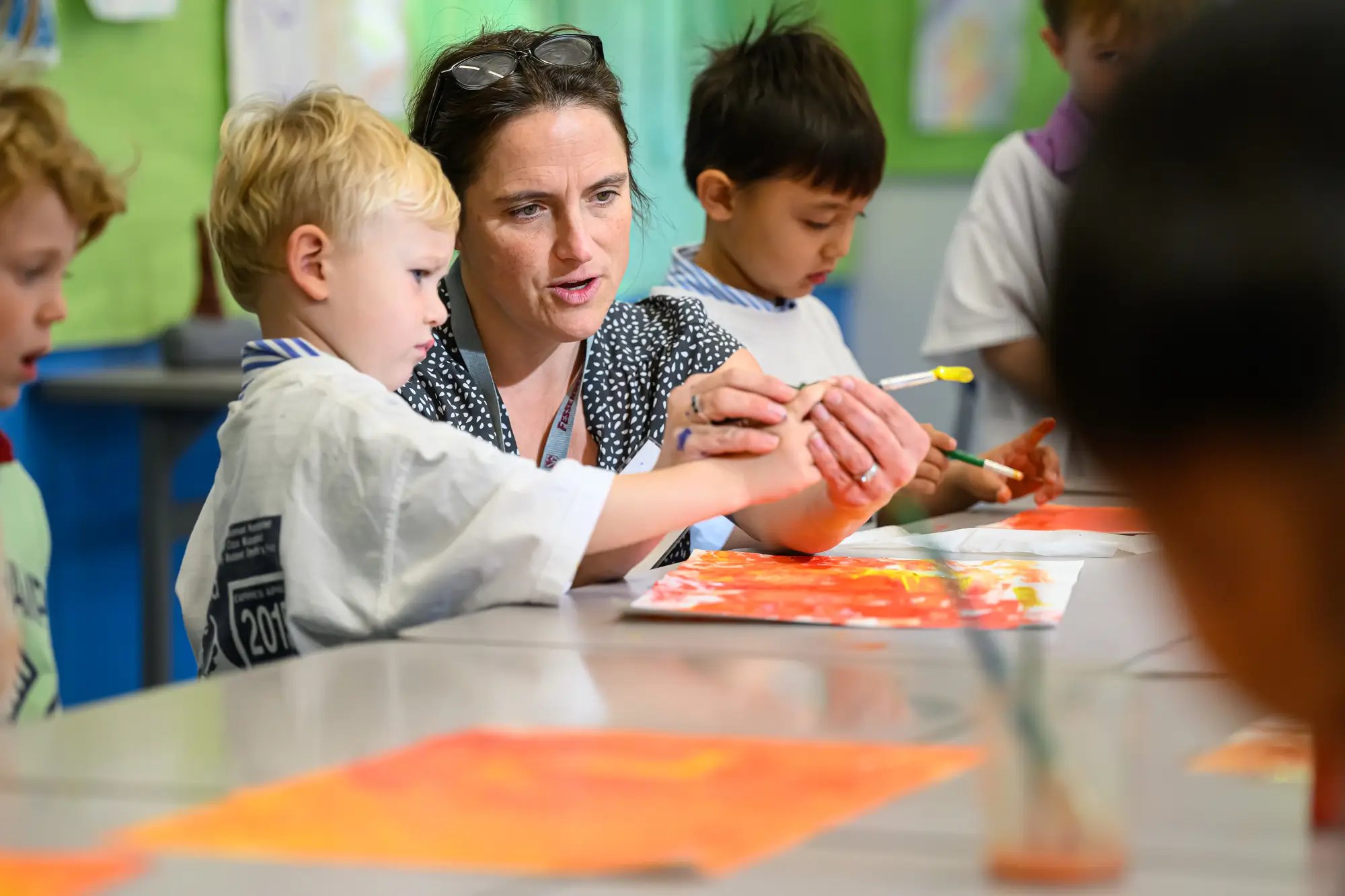 Student painting with teacher