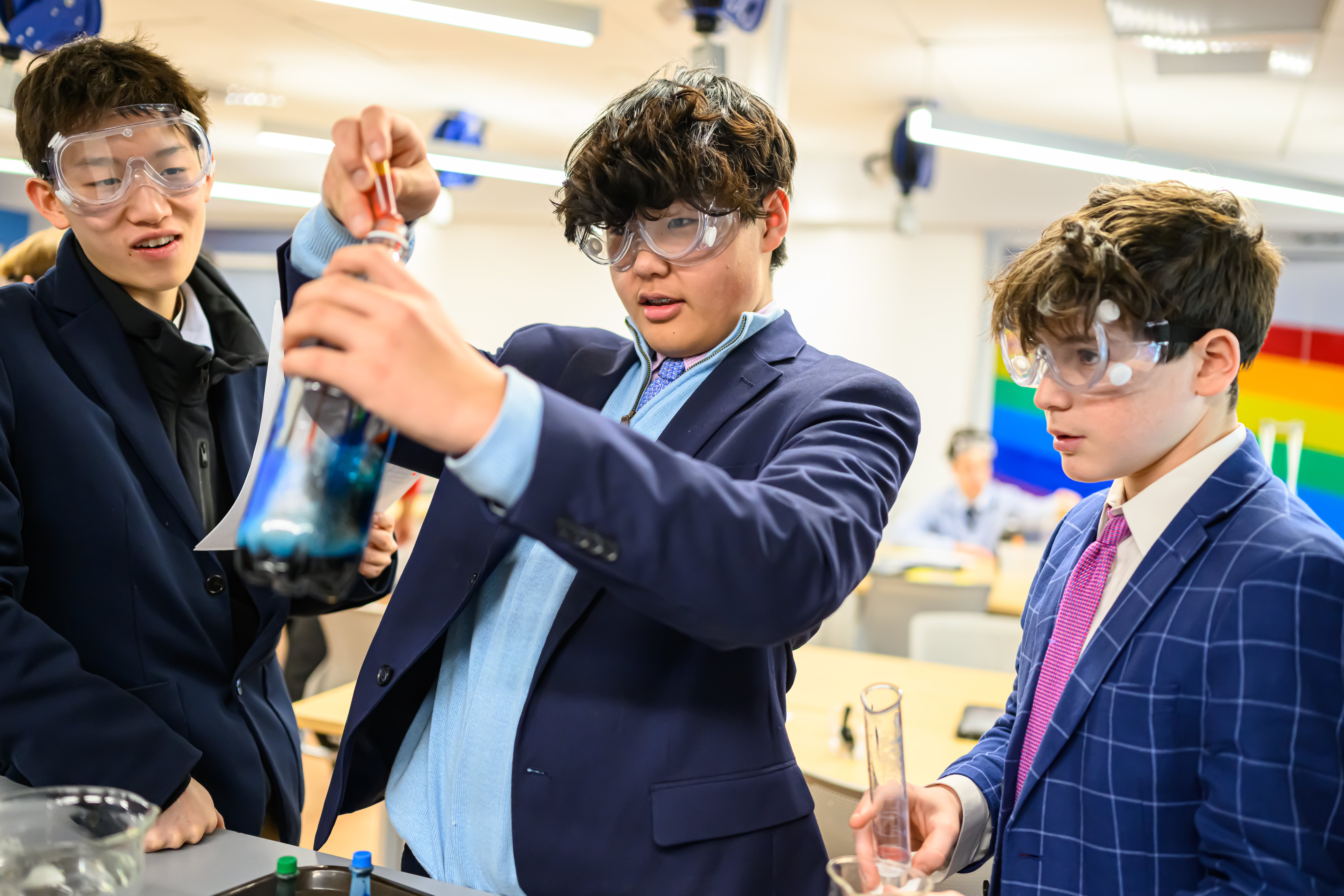 Fessenden students in protective glasses doing an experiment