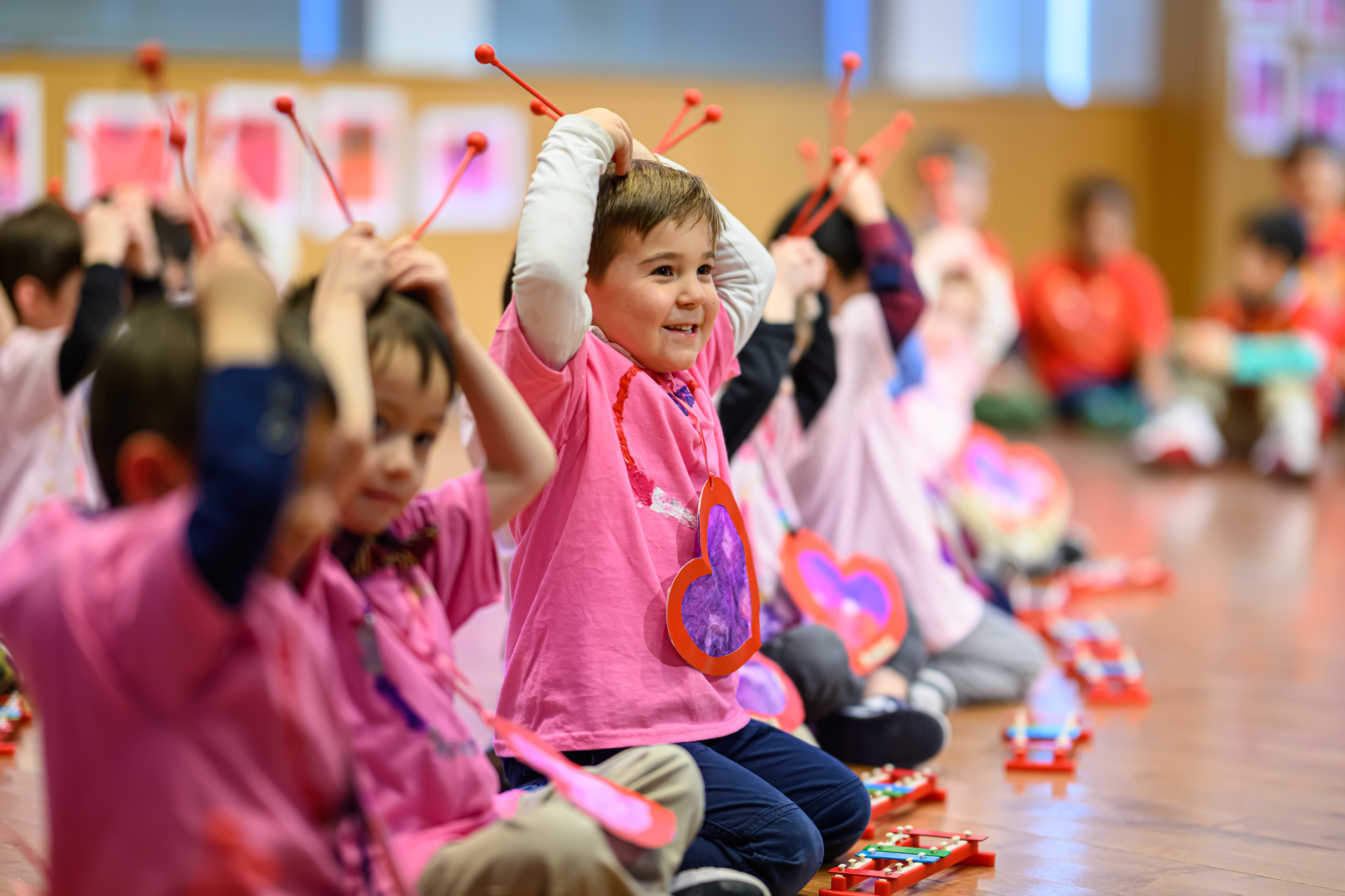 Elementary school students at Fessenden all wearing pink and playing the xylophone during class
