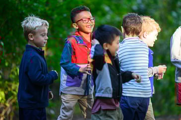 Kindergarteners at The Fessenden School talking to each other and playing outside. 
