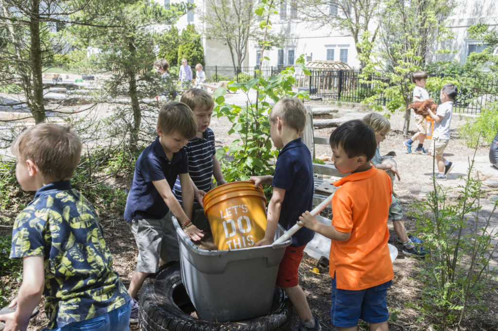 Pre-K students from The Fessenden School outside gardening and shoveling dirt.