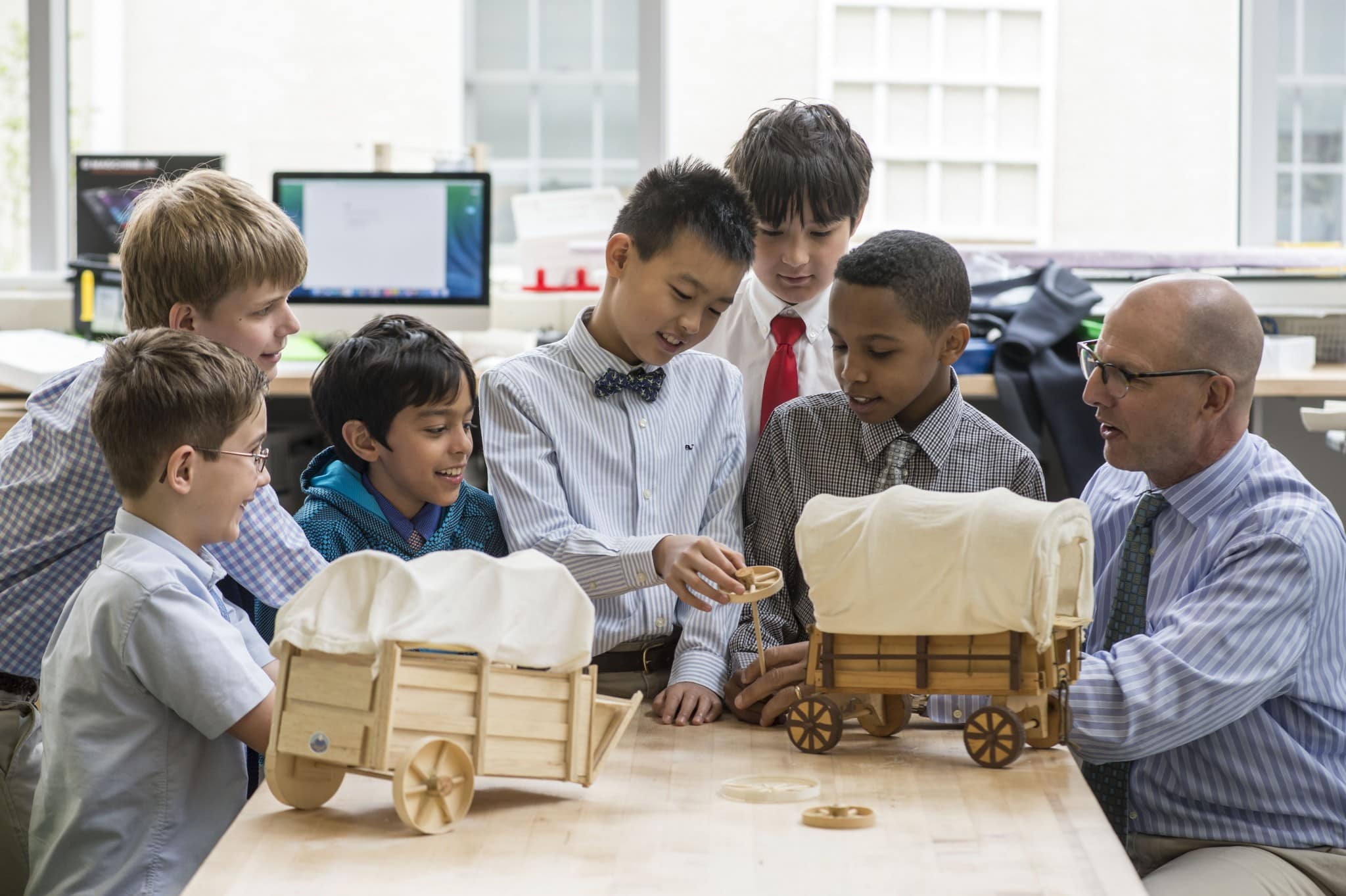 Six elementary school students at Fessenden working with a team during class.
