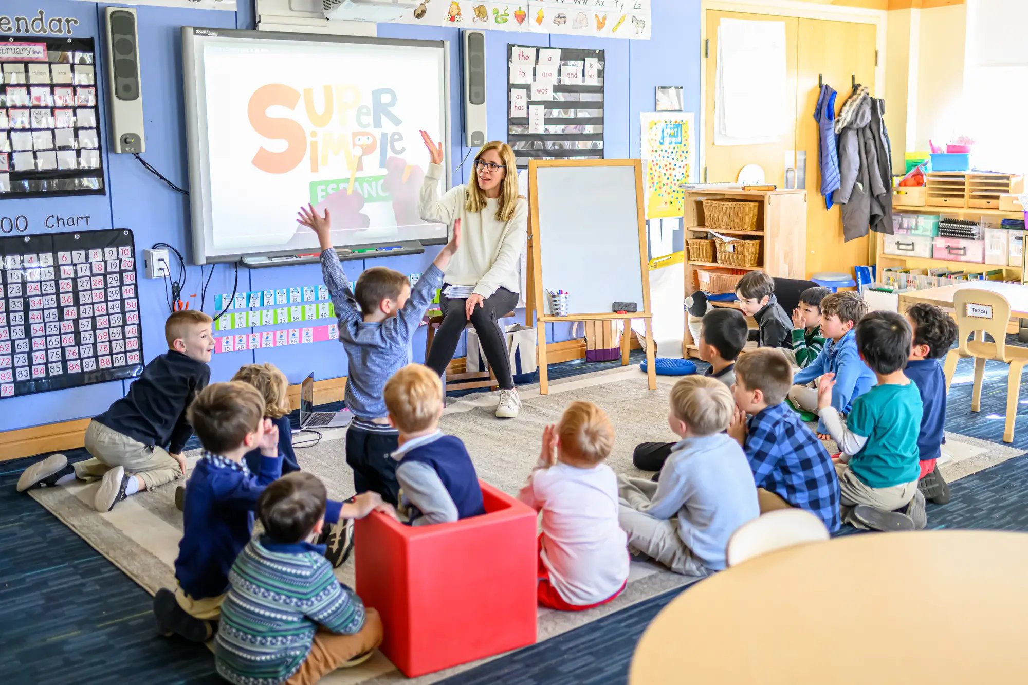 a group of kindergarteners listen to a teacher