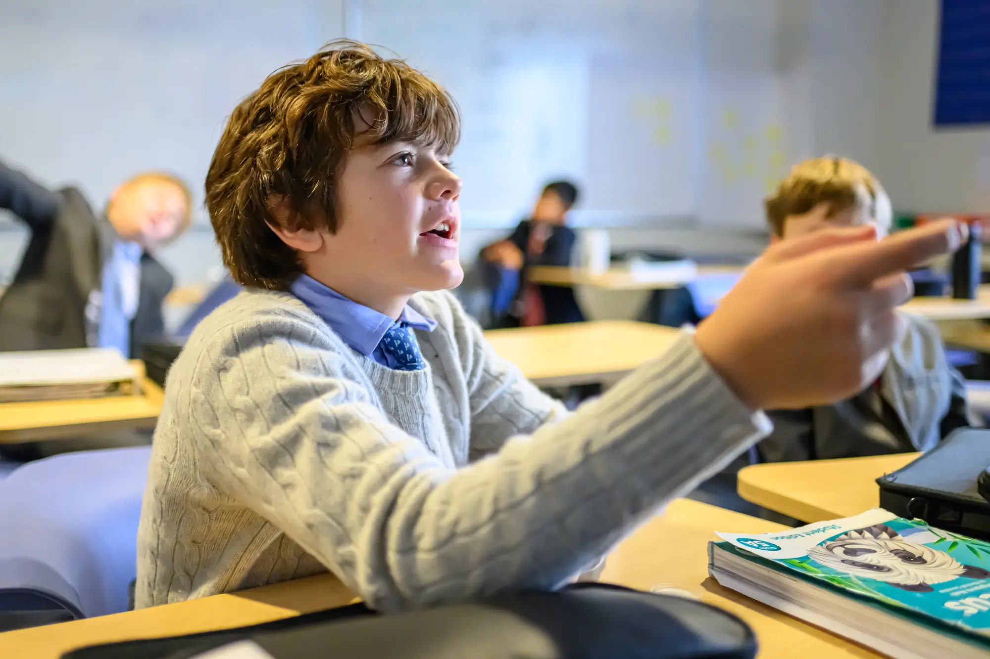 middle school boy participates in class