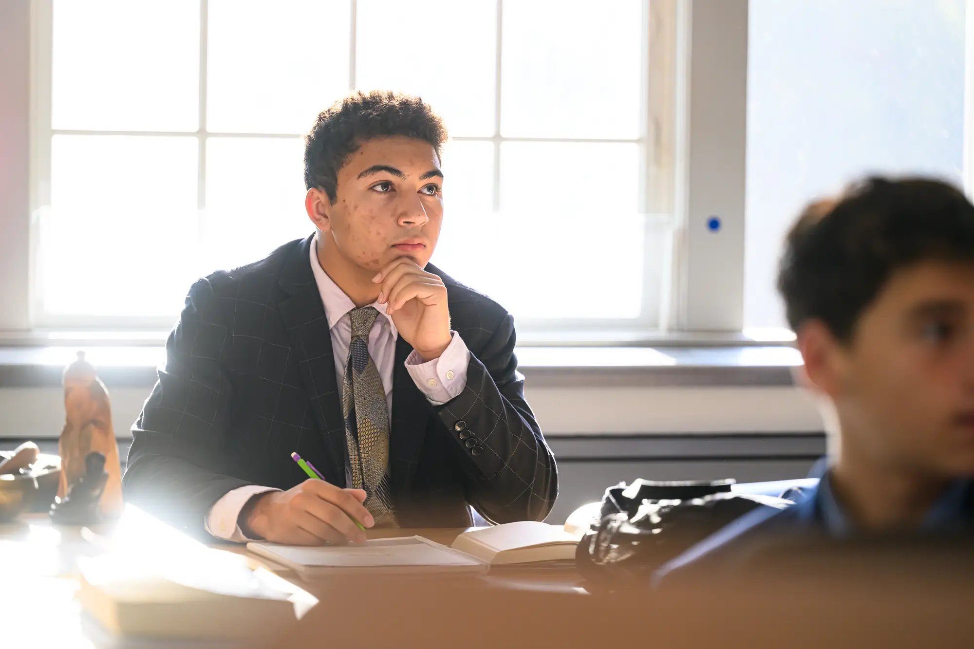 a high school boy pays attention in class