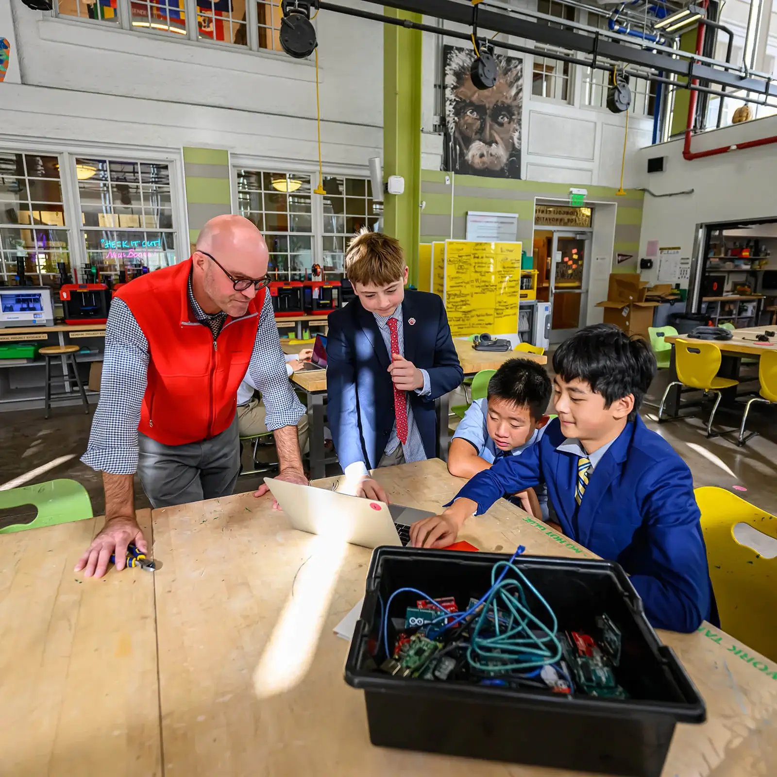 Boys and teacher working on project together in the Innovation Center