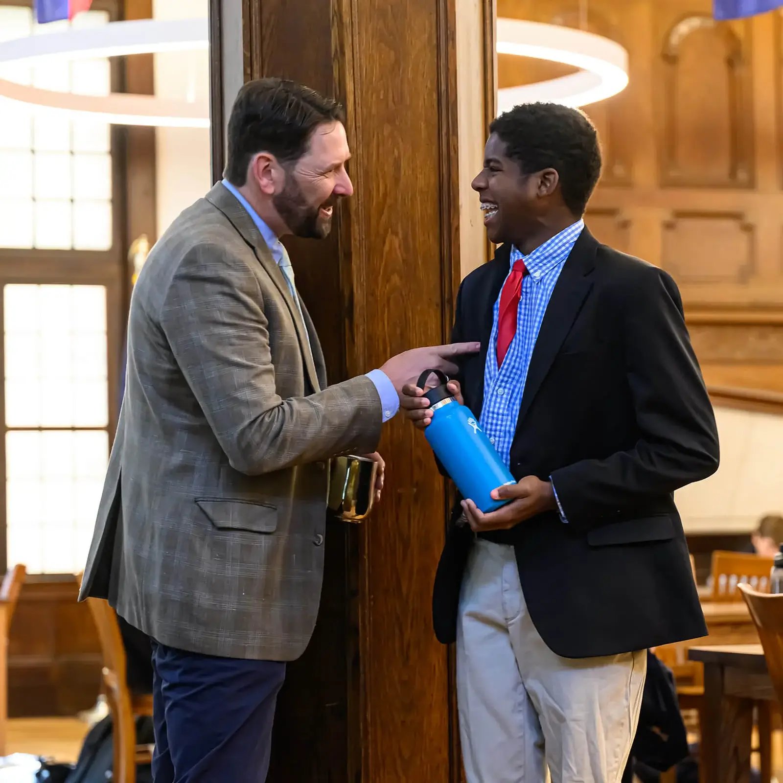 Boy and teacher smiling and talking