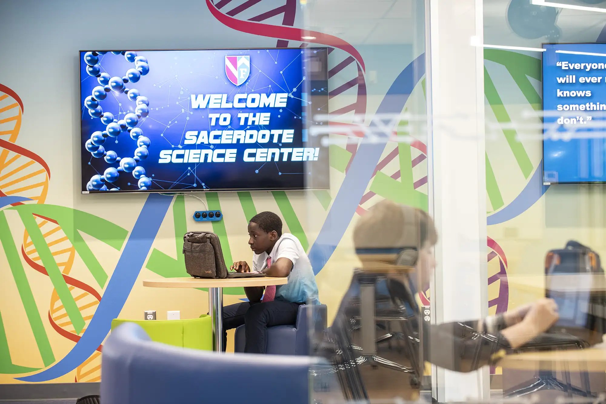 Student using laptop in Sacerdote Science Center