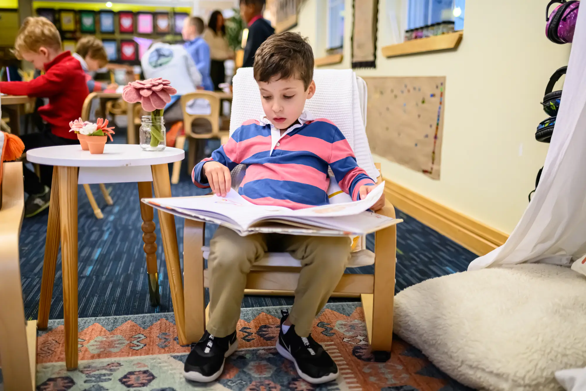 a young student in Kindergarten reading nook