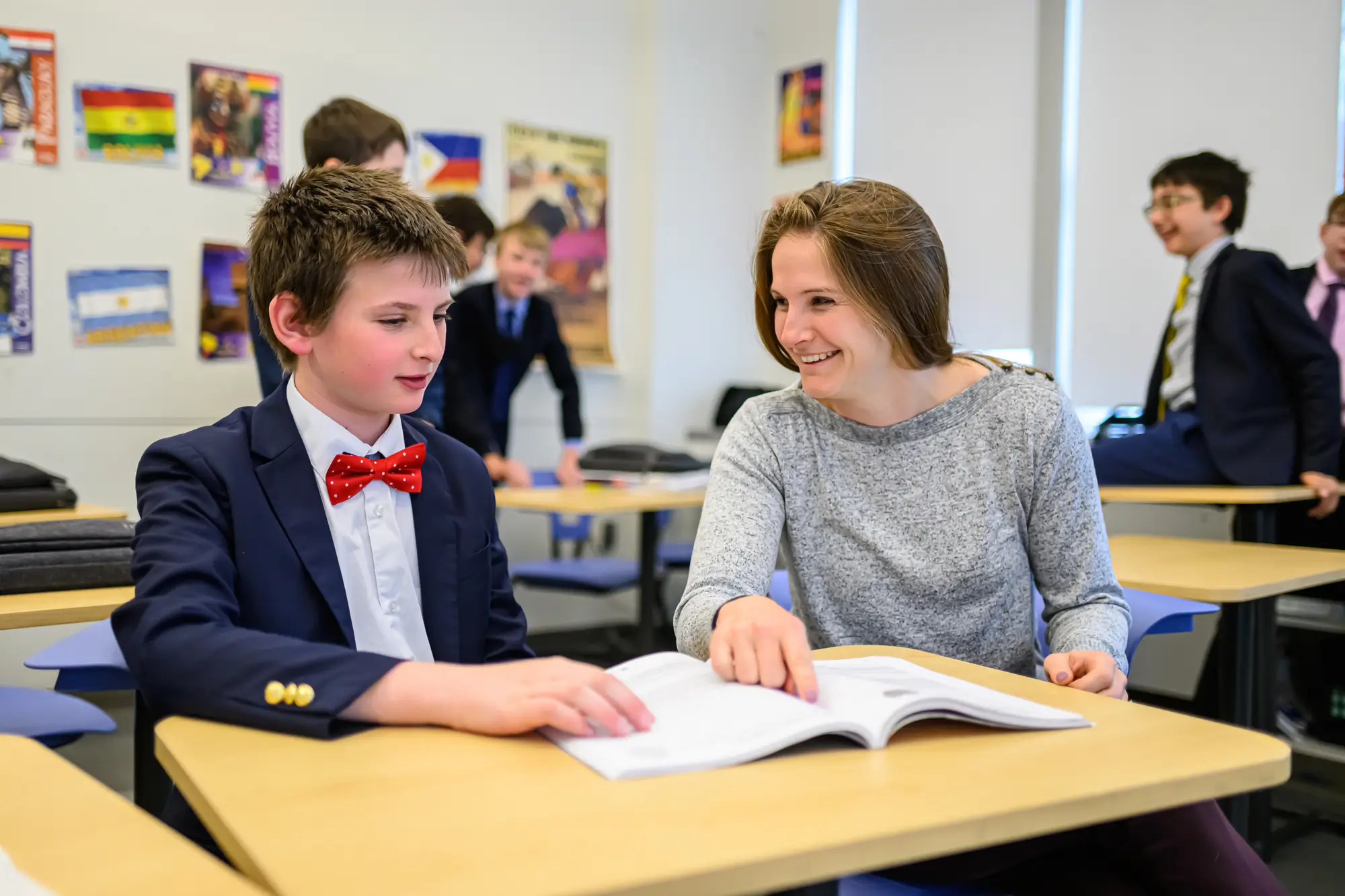 a female teacher helps a boy student