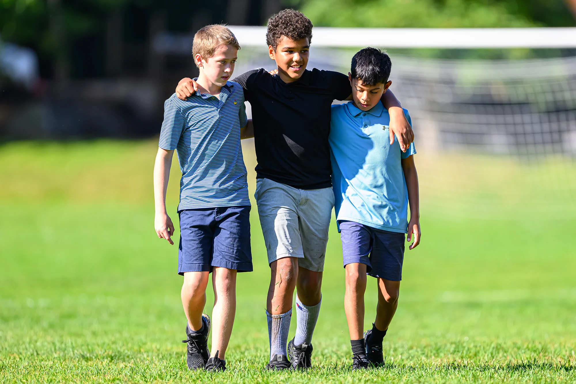 Boys walking on soccer field